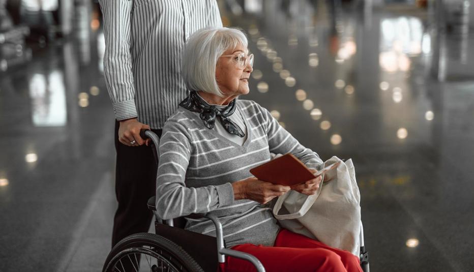 A woman using a wheelchair in an airport.