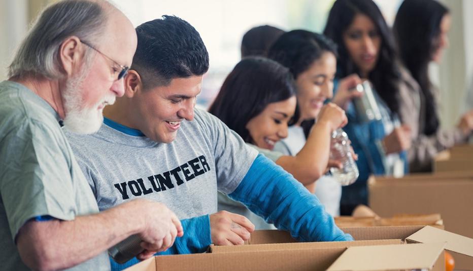 A group of volunteers packing boxes at a food bank