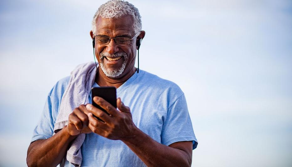 man using smartphone on mountain trail