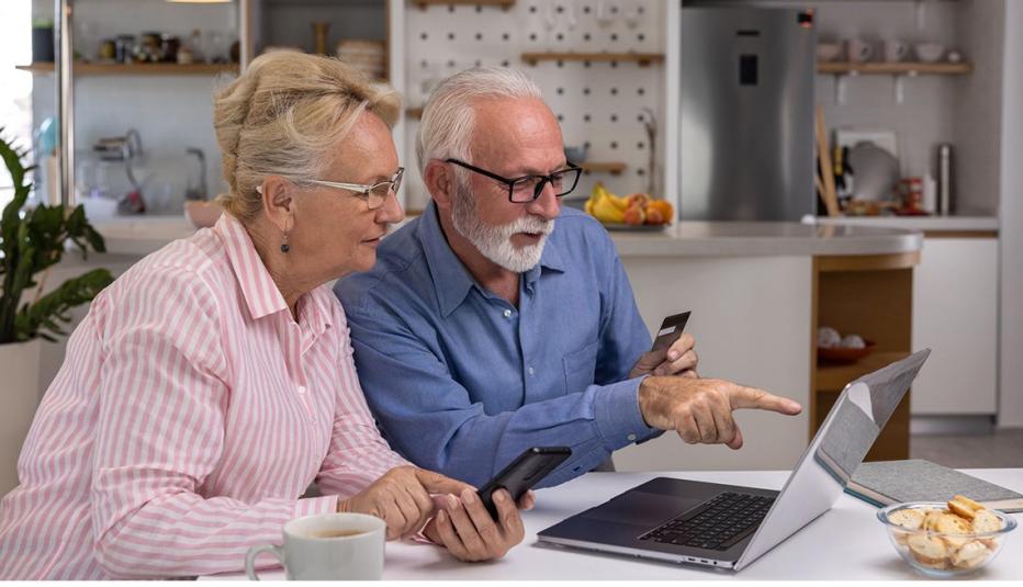 Senior couple viewing laptop Senior couple viewing laptop