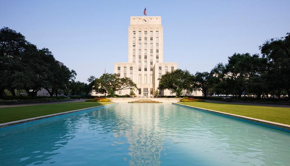 "Houston City Hall over pond in urban park, Houston, Texas, United States"