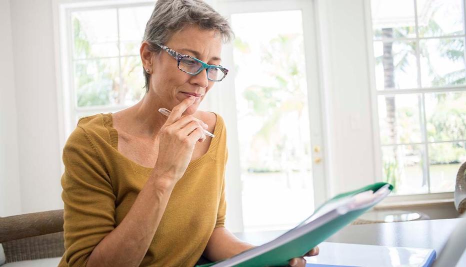 Older woman looking at folder Older woman looking at folder