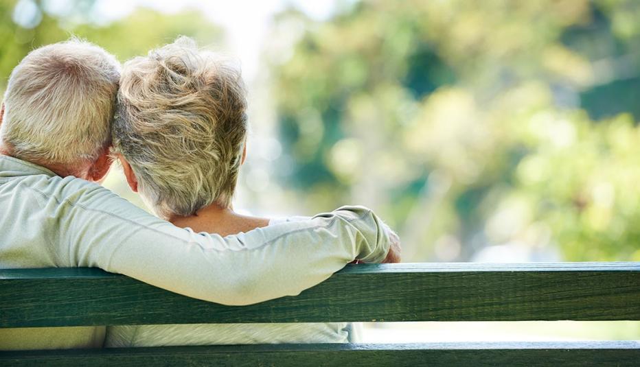 Older couple sitting on park bench