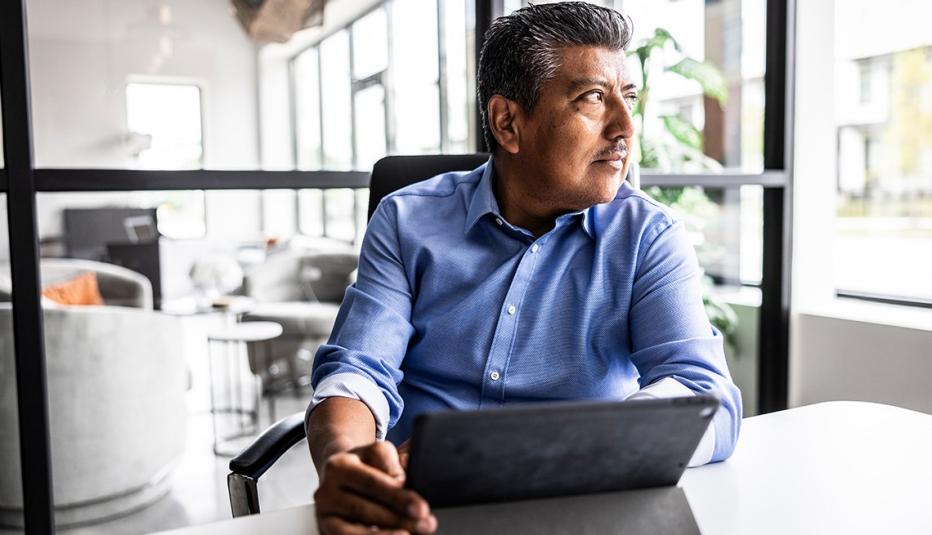 Businessman looking out window in modern office
