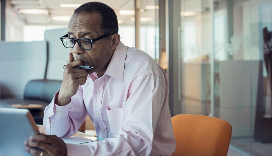 Businessman working alone in office using digital tablet 