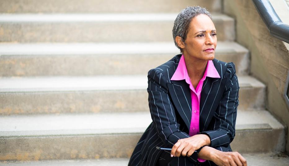 Female in business suit sitting on stairs