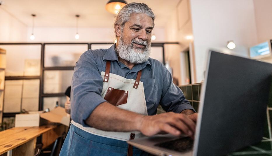 Male Latino Business owner using laptop