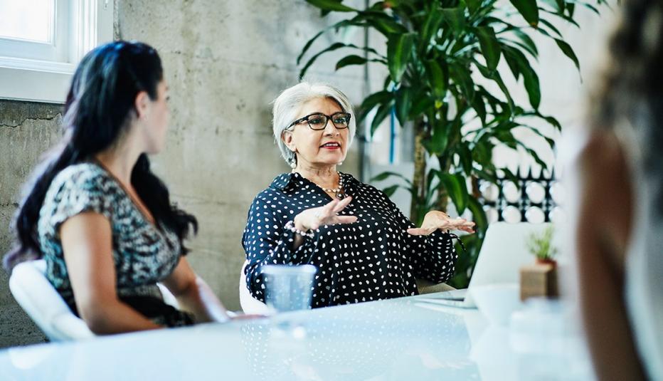 woman in a conference room meeting with colleagues