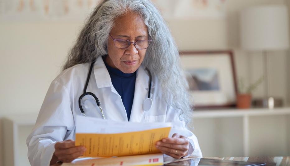 A Look at Employment of Older Workers by Industry and Occupation A mature adult female doctor of Pacific Islander and Asian descent reviews a patient's file while working in her office.