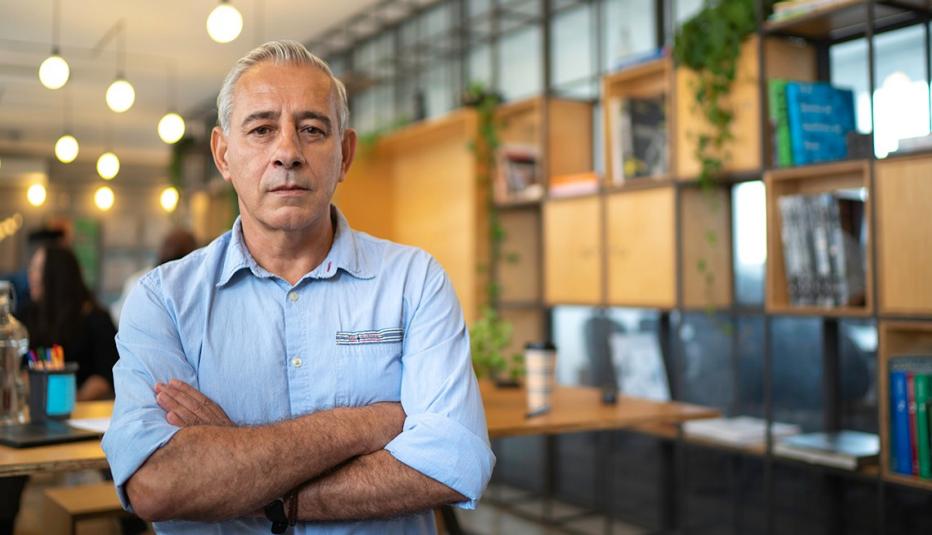 Small business owner standing in front of shelves