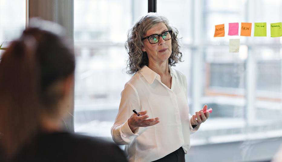 Businesswoman giving presentation in board room at office