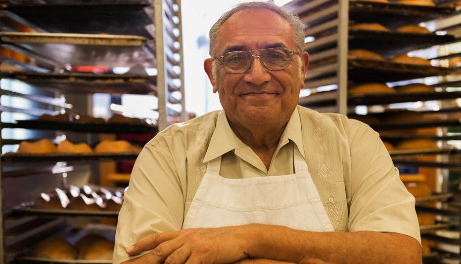 Hispanic baker working in commercial kitchen 