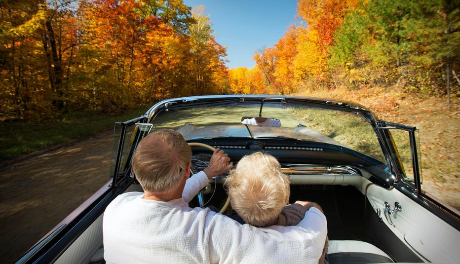Retired couple enjoying an Autumn drive. Retired couple enjoying an Autumn drive.