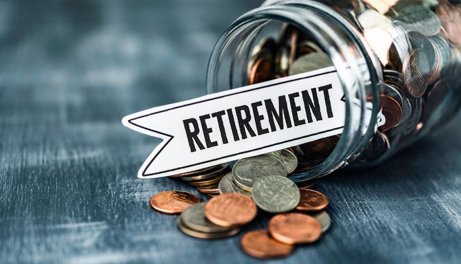 Money background of glass jar filled with coins and RETIREMENT message