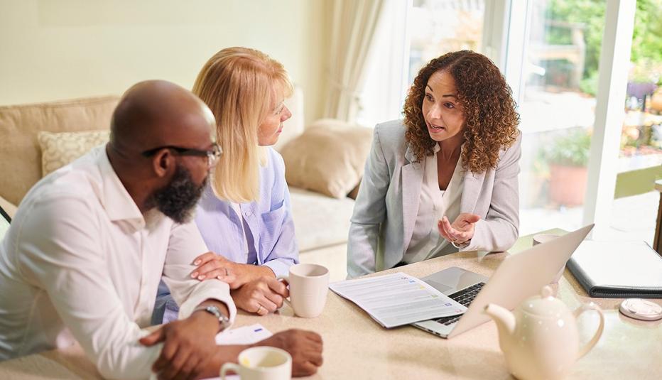 mature couple meeting with their financial planner at home