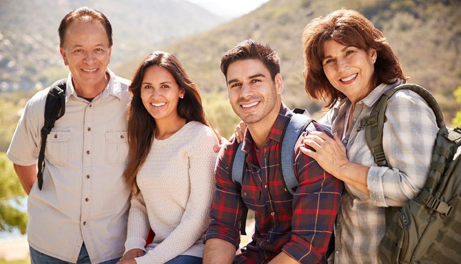Couple and senior parents taking a break on a mountain walk