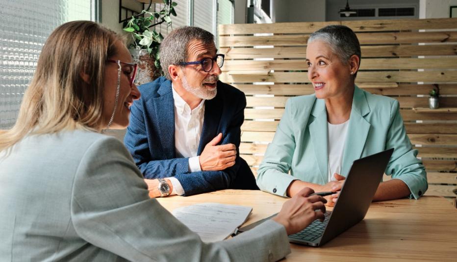 A financial advisor meeting with clients