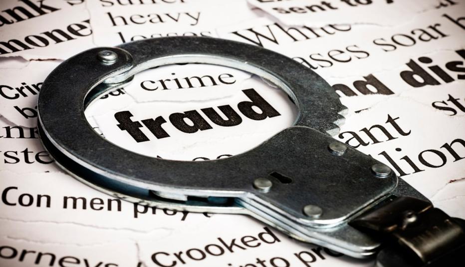 Fraud The word fraud with handcuffs