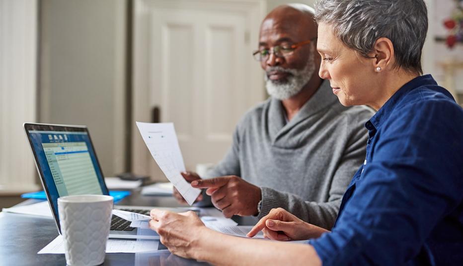 Couple work on finances at home Couple work on finances at home