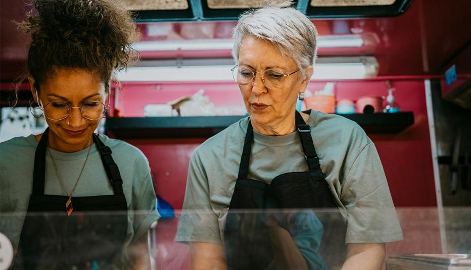 Female new food business owners working together in concession stand - stock photo

