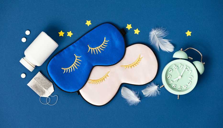 tea, feathers, pills, masks, and an alarm clock on a blue field