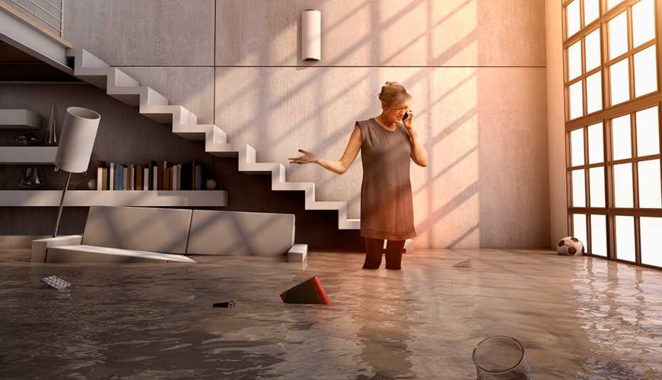 Woman talking on cell phone in flooded house