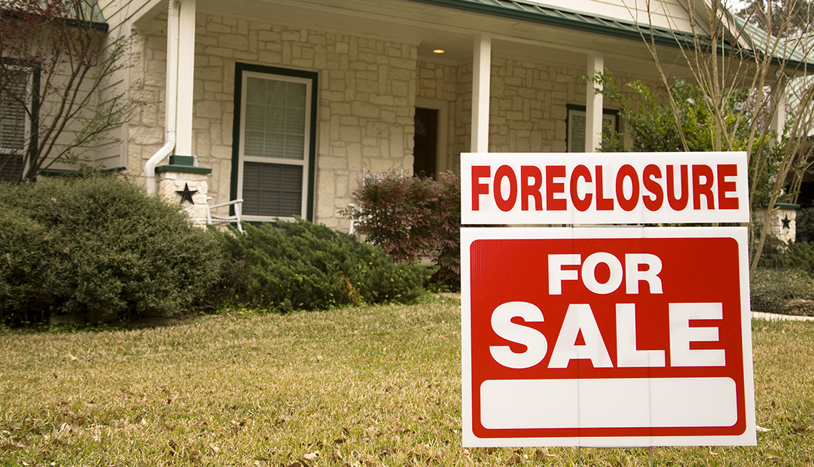 foreclosure sign in front of a house