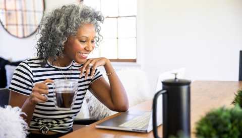 Woman watches a webinar on her laptop