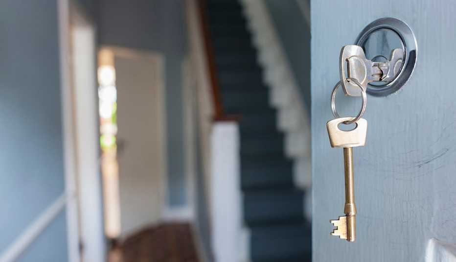 The front door of a house with key in the lock