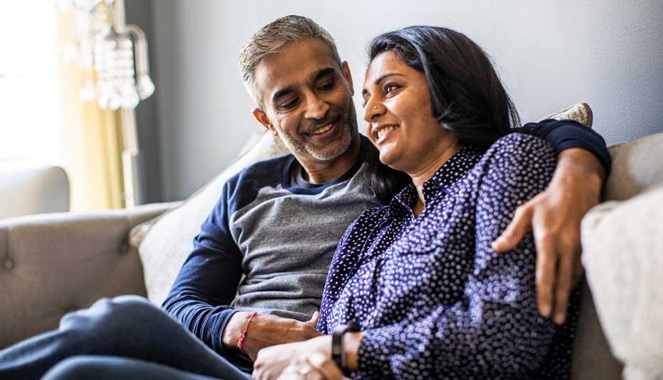 happy couple sitting in their home