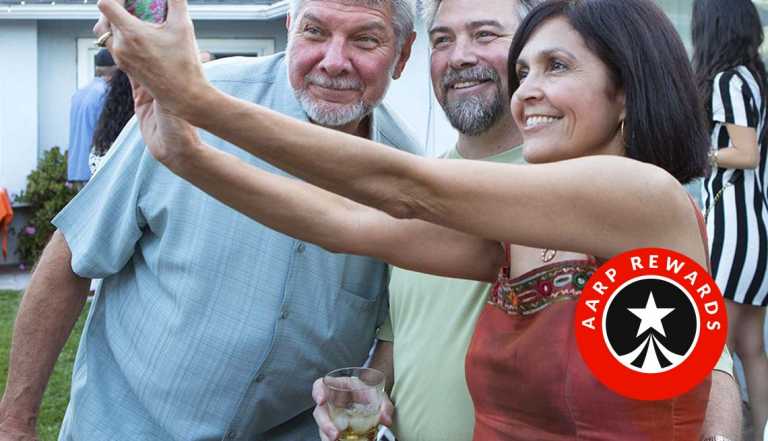 A woman talking a selfie with two men