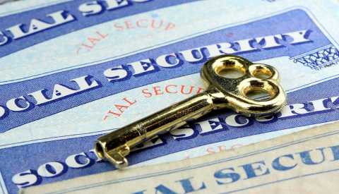 gold key laying on social security cards gold key laying on social security cards
