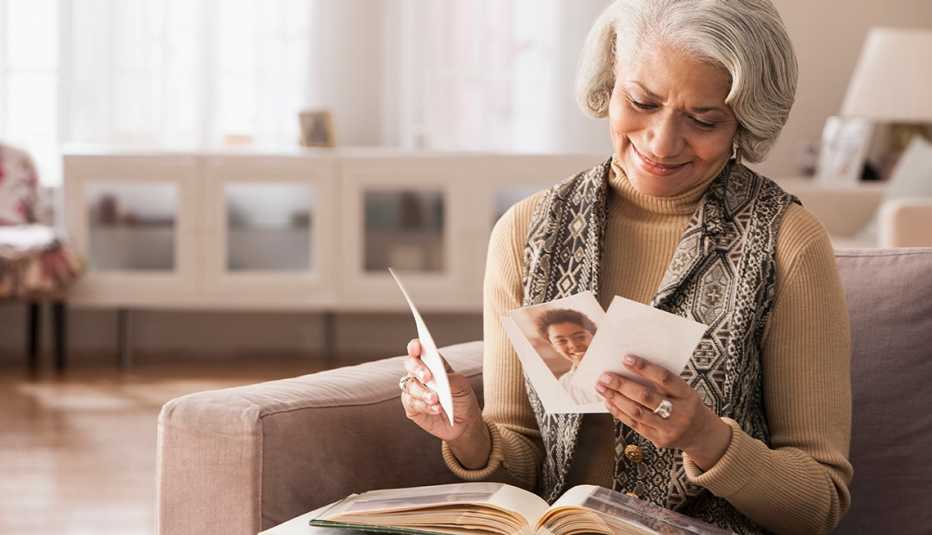 woman looking at old photos at home