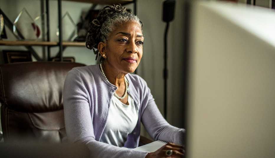 woman seated at a desktop computer