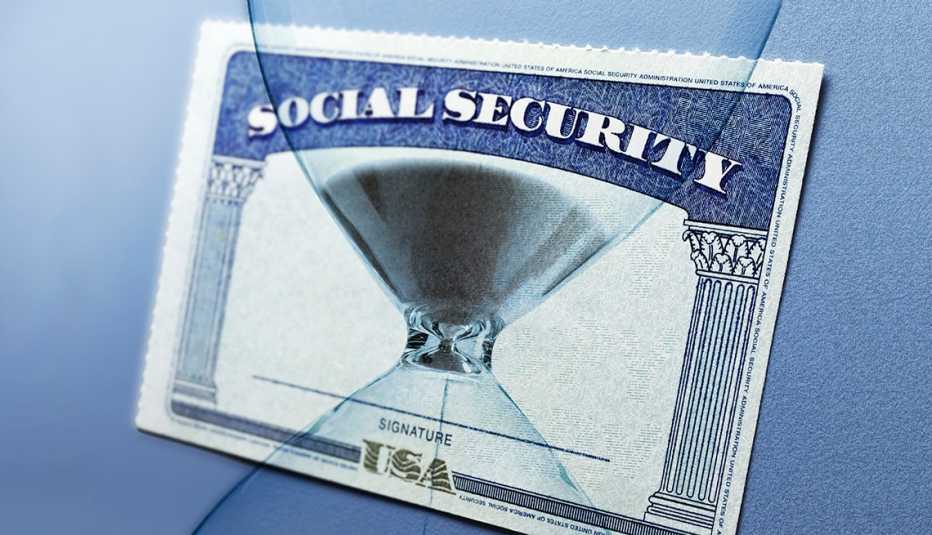 hourglass montaged on top of a social security card. hourglass montaged on top of a social security card.
