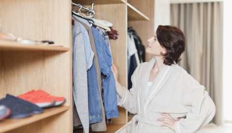 A woman looking at her clothes in the closet