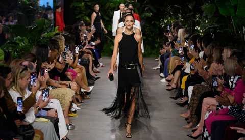 Models walking the runway in front of an audience at the Michael Kors Spring 2023 fashion show