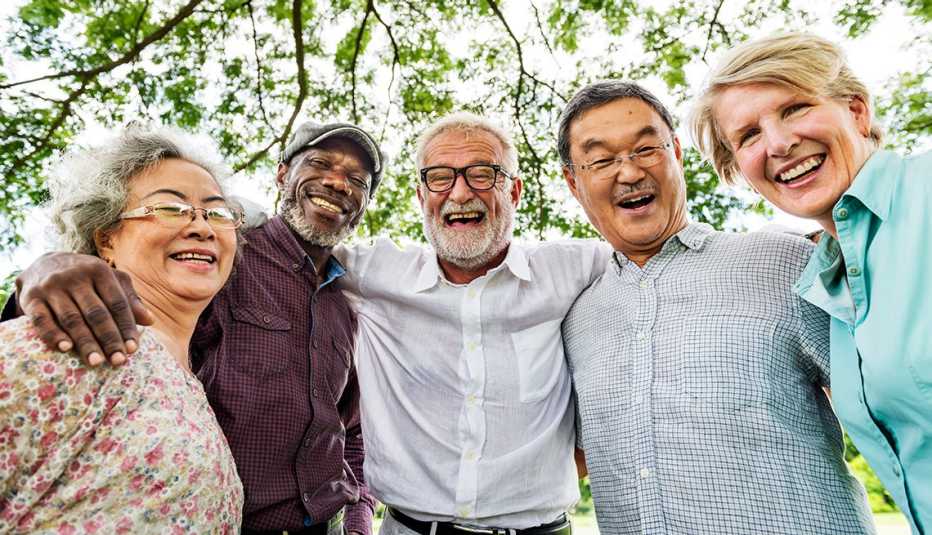 three men and two women with arms linked