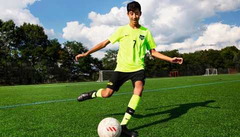 teen boy playing soccer