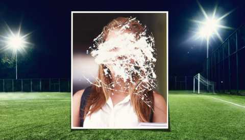 yearbook photo with the face scratched out over a soccer pitch