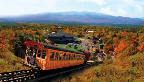 fall foliage surrounding the mount washington cog railway in new hampshire
