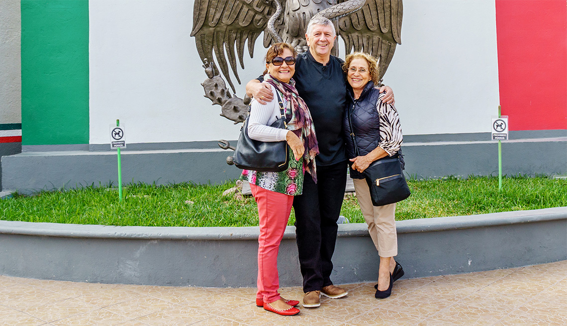 Three tourists on bridge between USA and Mexico