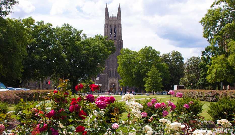 duke university chapel with trees surrounding it and flowers in front duke university chapel with trees surrounding it and flowers in front
