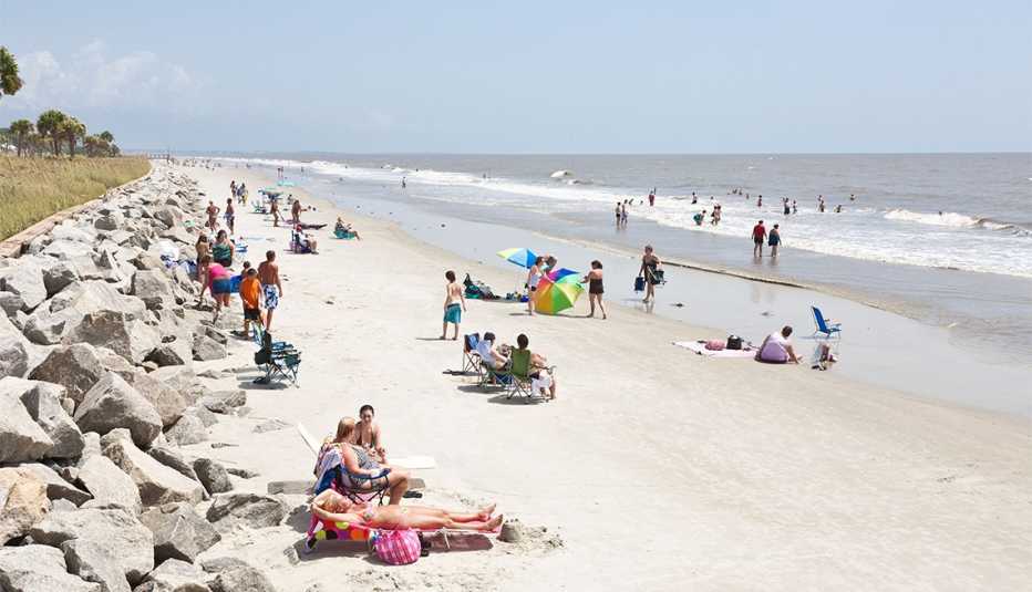 Sunbathers and colorful beach umbrellas on the public beach at Jekyll Island, Georgia