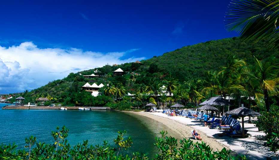 people sunbathing on a beach in virgin gorda island in the carribean