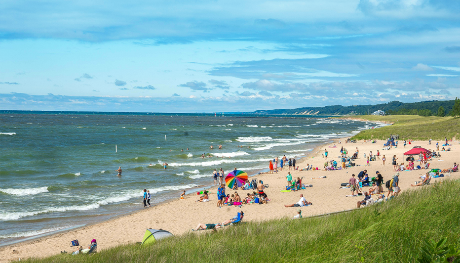 people at oval beach on lake michigan in saugatuck michigan