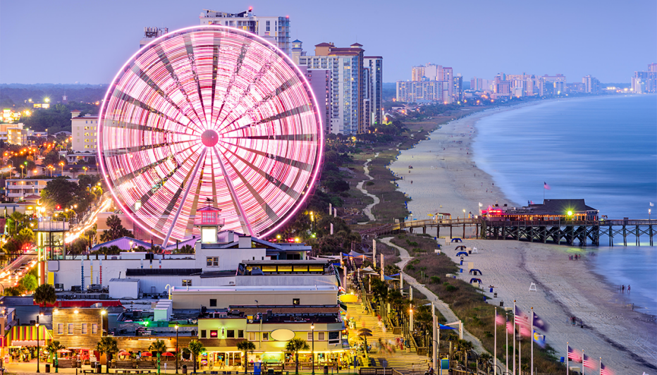 a ferris wheel spins over myrtle beach in south carolina