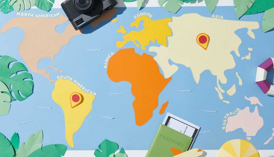 Map with outline of continents on it map with outline of different continents; passport on bottom; camera on top