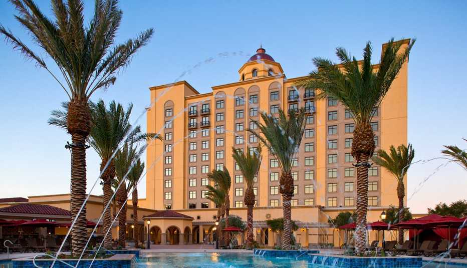 Exteror of the Casino Del Sol with a pool and palm trees in front