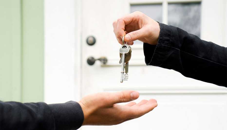 Person exchanging keys with another.